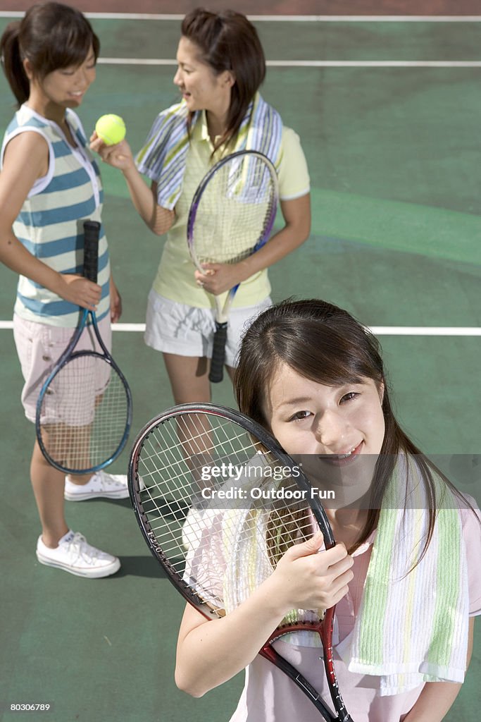 Three young women at tennis court