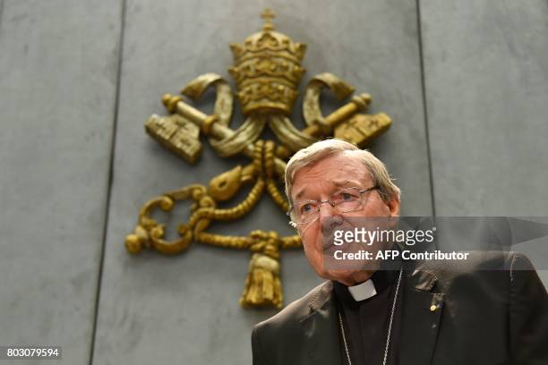 Australian Cardinal George Pell looks on as he makes a statement at the Holy See Press Office, Vatican city on June 29, 2017 after being charged with...