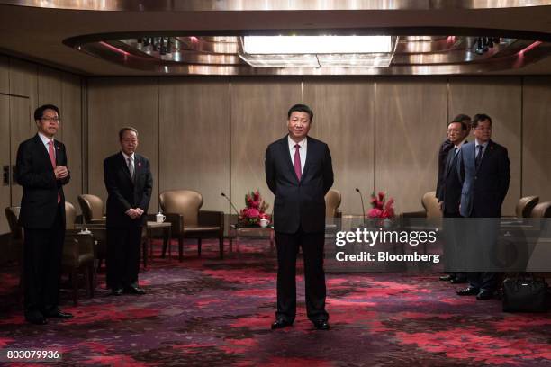 Xi Jinping, China's president, center, stands ahead of a meeting with Leung Chun-ying, Hong Kong's outgoing chief executive, not pictured, in Hong...