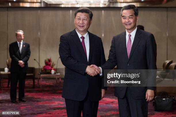 Xi Jinping, China's president, left, shakes hands with Leung Chun-ying, Hong Kong's outgoing chief executive, during a meeting in Hong Kong, China,...