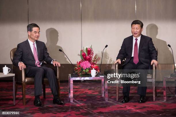 Xi Jinping, China's president, right, speaks as Leung Chun-ying, Hong Kong's outgoing chief executive, looks on during a meeting in Hong Kong, China,...