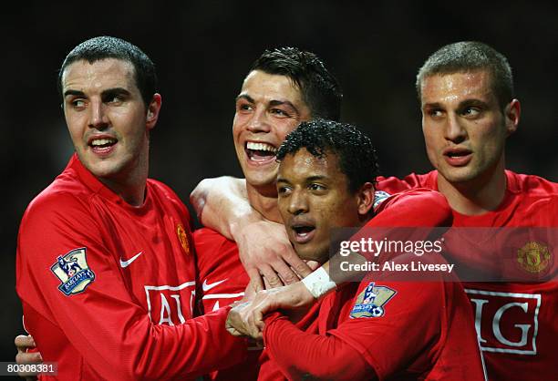 Cristiano Ronaldo of Manchester United celebrates with team mates John O'Shea , Luis Nani and Nemanja Vidic as he scores their second goal during the...