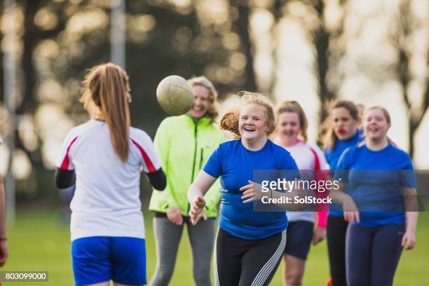 teen girls playing rugby - sport venue stock pictures, royalty-free photos & images