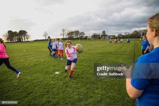 teen girls playing a game of rugby - angry rugby player stock pictures, royalty-free photos & images