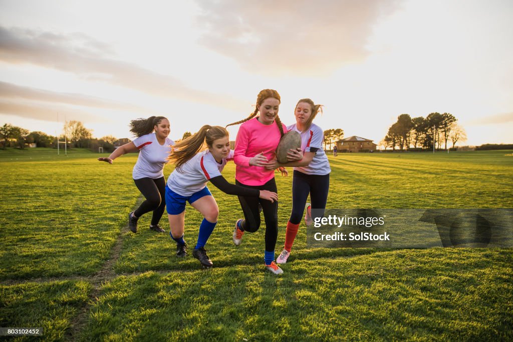 Teen Girls Playing a Game of Rugby