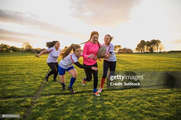 teen girls playing a game of rugby - rugby club stock pictures, royalty-free photos & images