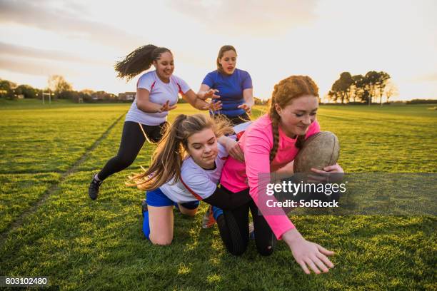 teen girls playing a game of rugby - angry rugby player stock pictures, royalty-free photos & images