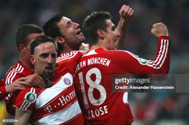 Franck Ribery of Munich celebrates scoring the first goal with his team mates during the DFB Cup semi final match between Bayern Munich and VfL...