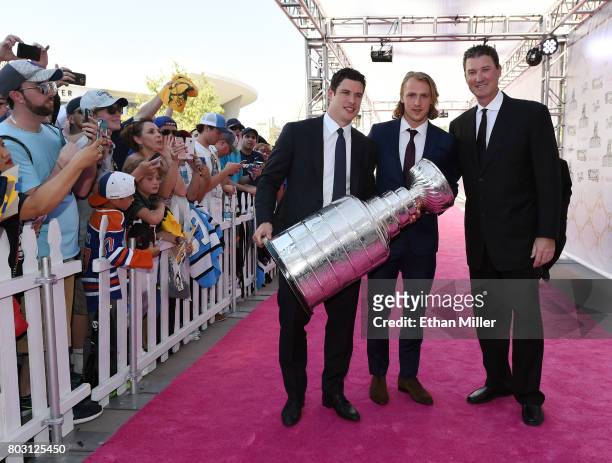 Sidney Crosby, Carl Hagelin and owner Mario Lemieux of the Pittsburgh Penguins carry the Stanley Cup as they arrive at the 2017 NHL Awards at...