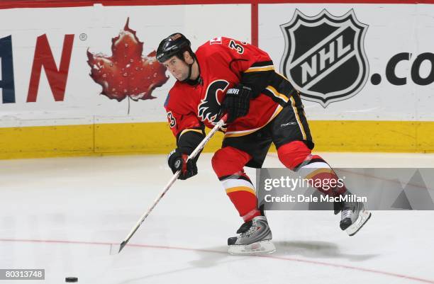 March 7: Adrian Aucoin of the Calgary Flames passes the puck against the Nashville Predators during their NHL game at the Pengrowth Saddledome on...