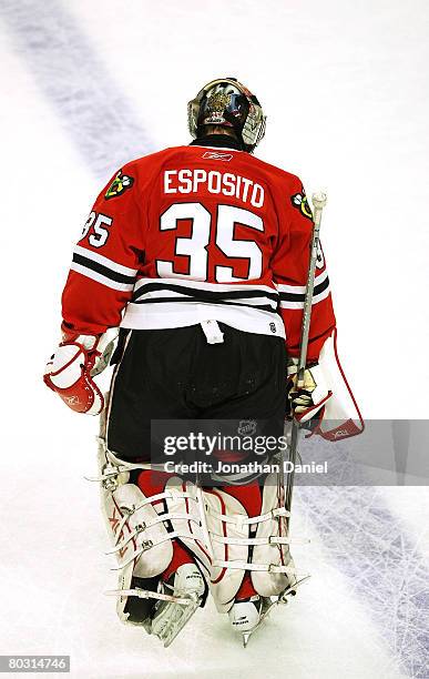 Goaltender Nikolai Khabibulin of the Chicago Blackhawks wears a jersey honoring former Blackhawk goaltender Tony Esposito during warm-ups before a...