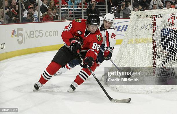 Patrick Kane of the Chicago Blackhawks carries the puck around the net as Jeff Schultz of the Washington Capitals follows on March 19, 2008 at the...