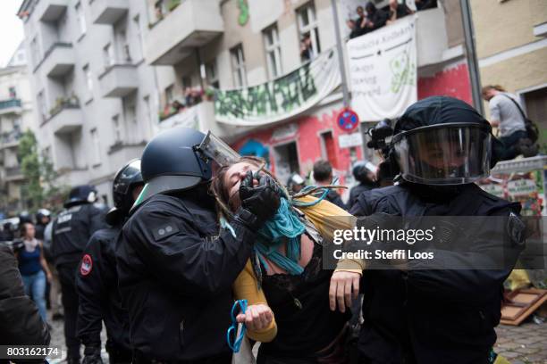 Police guide protesters off the scene during an eviction operation at the Friedel 54 shop on June 29, 2017 in Berlin, Germany. The shop is a popular...