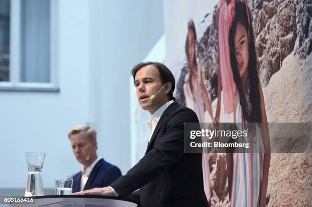 Karl-Johan Persson, chief executive officer of Hennes & Mauritz AB , right, speaks as Nils Vinge, head of investor relations at Hennes & Mauritz AB,...