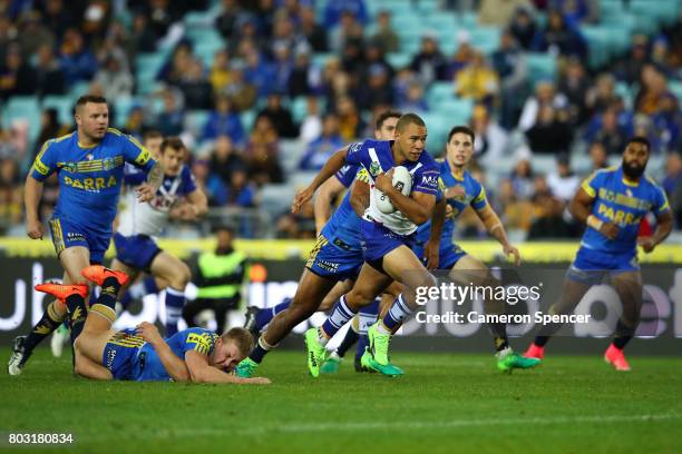 Moses Mbye of the Bulldogs makes a break during the round 17 NRL match between the Parramatta Eels and the Canterbury Bulldogs at ANZ Stadium on June...