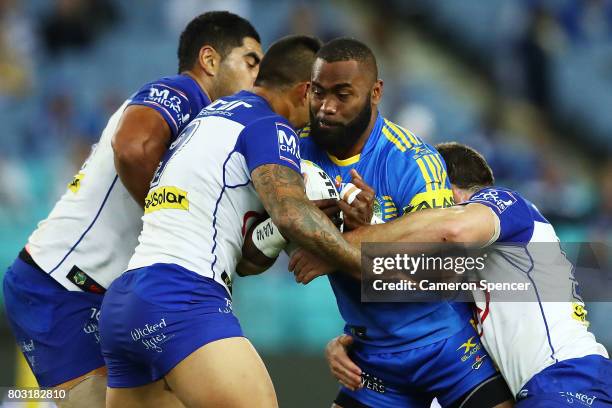 Semi Radradra of the Eels is tackled during the round 17 NRL match between the Parramatta Eels and the Canterbury Bulldogs at ANZ Stadium on June 29,...