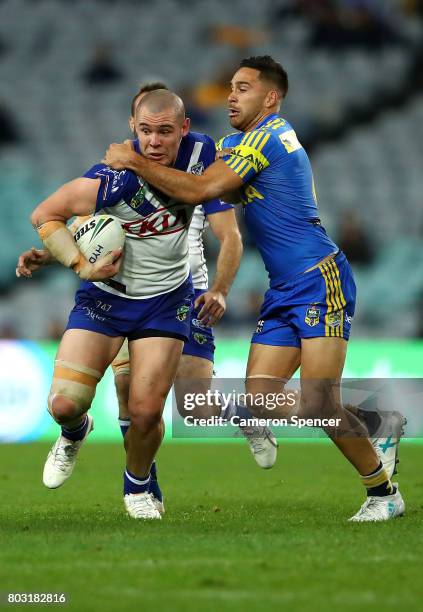 David Klemmer of the Bulldogs is tackled during the round 17 NRL match between the Parramatta Eels and the Canterbury Bulldogs at ANZ Stadium on June...