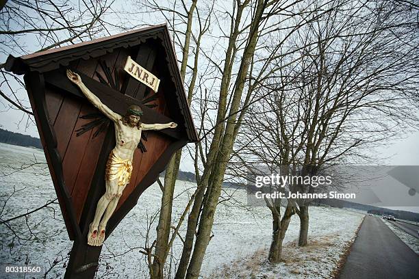 Crucifix is seen beside a snowy field on March 20, 2008 near Eresing, Germany. The weather forecasts predict wet, rainy and regional snowy weather...