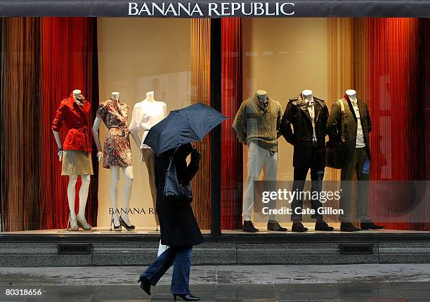 Members of the public pass the Banana Republic store on a rainy day on the corner of Regent Street and Marlborough Road on March 20, 2008 in London,...