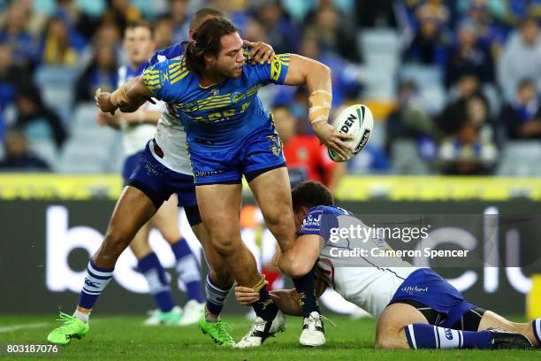 Tepai Moeroa of the Eels offloads the ball during the round 17 NRL match between the Parramatta Eels and the Canterbury Bulldogs at ANZ Stadium on...