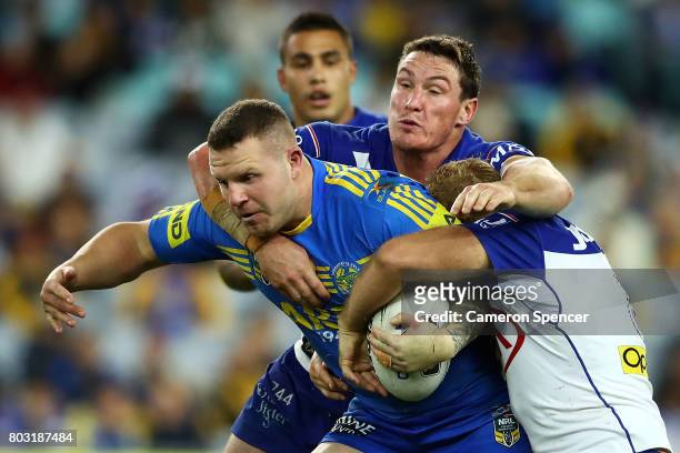 Nathan Brown of the Eels is tackled during the round 17 NRL match between the Parramatta Eels and the Canterbury Bulldogs at ANZ Stadium on June 29,...