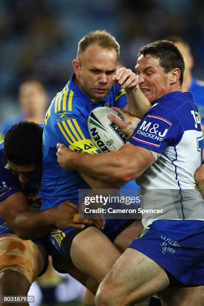 David Gower of the Eels is tackled during the round 17 NRL match between the Parramatta Eels and the Canterbury Bulldogs at ANZ Stadium on June 29,...