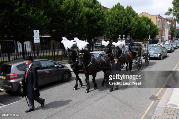 Horse-drawn carriage leads the procession ahead of the funeral of one of the victims of the fire in Grenfell Tower, on June 29, 2017 in London,...