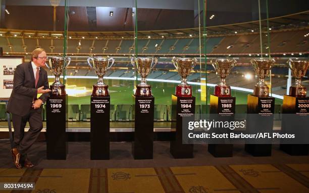 Kevin Sheedy stands next to AFL Premiership Cups he won after being a part of seven premiership teams during the '50 Years of Sheeds' Dinner on June...