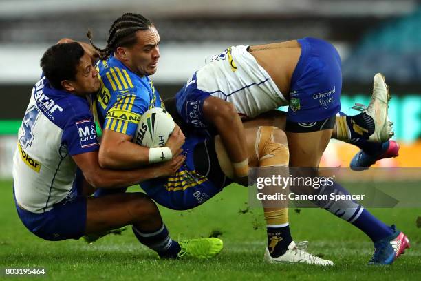 Bradley Takairangi the Eels is tackled during the round 17 NRL match between the Parramatta Eels and the Canterbury Bulldogs at ANZ Stadium on June...