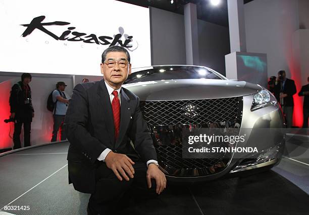 Hiroshi Tsuda, President and chief operating officer of Suzuki Motor Corportation, poses with the Suzuki Kizashi 3 concept sports sedan on March 20,...