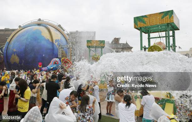 The Universal Summer Festival which involves people getting soaked with water from being splashed at Universal Studios Japan in Osaka is shown to the...