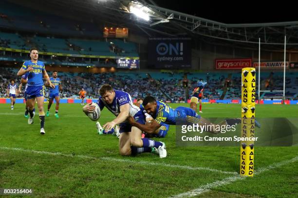Brett Morris of the Bulldogs scores a try during the round 17 NRL match between the Parramatta Eels and the Canterbury Bulldogs at ANZ Stadium on...