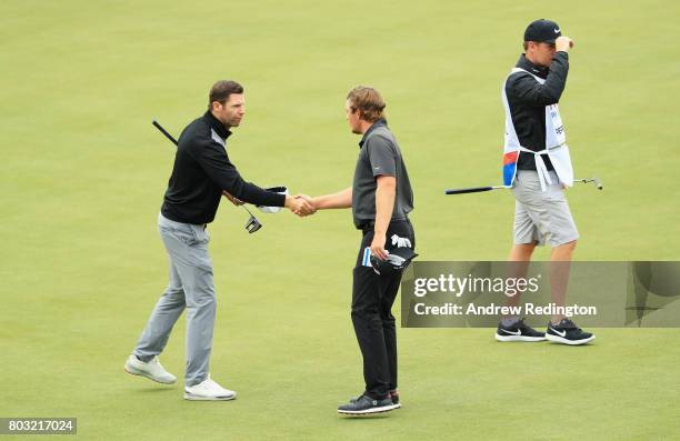 Bradley Dredge of Wales shakes hands with Eddie Pepperell of England on the 18th green during day one of the HNA Open de France at Le Golf National...