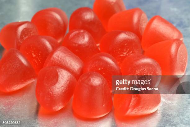 orange colored and fruit flavored soft chew gummy vitamins - vitamins and minerals stock pictures, royalty-free photos & images