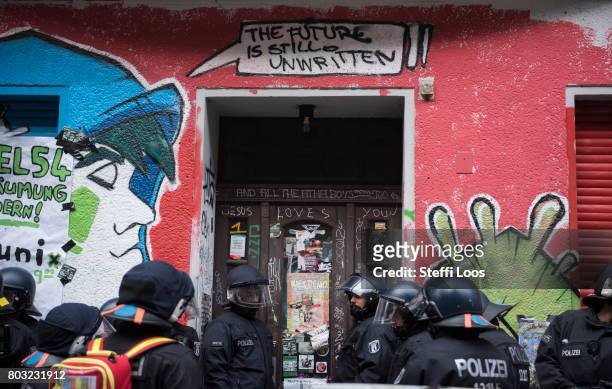 Police stands in front of a grafitti that reads "The future is unwritten" at Friedel 54 shop in Neukoelln district during an eviction operation on...