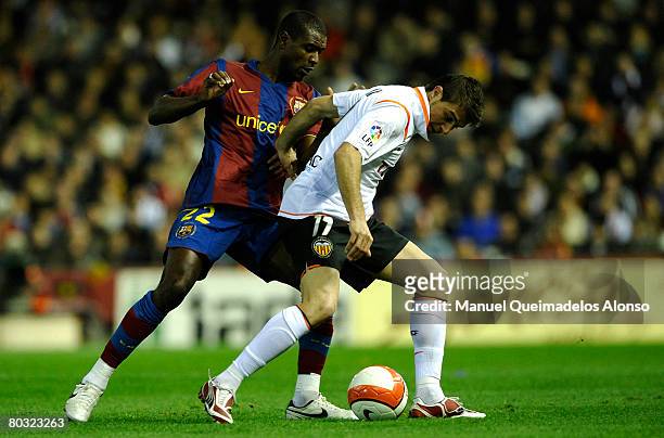 Eric Abidal of Barcelona and Joaquin Sanchez of Valencia battle for the ball during the Copa del Rey Semi Final 2nd leg match between Valencia and...