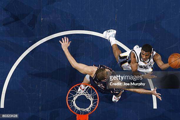 Mike Conley of the Memphis Grizzlies goes up for a shot against Josh Boone of the New Jersey Nets during the game at the FedExForum on March 5, 2008...