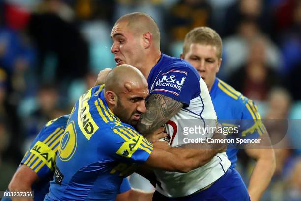Tim Mannah of the Eels tackles David Klemmer of the Bulldogs during the round 17 NRL match between the Parramatta Eels and the Canterbury Bulldogs at...