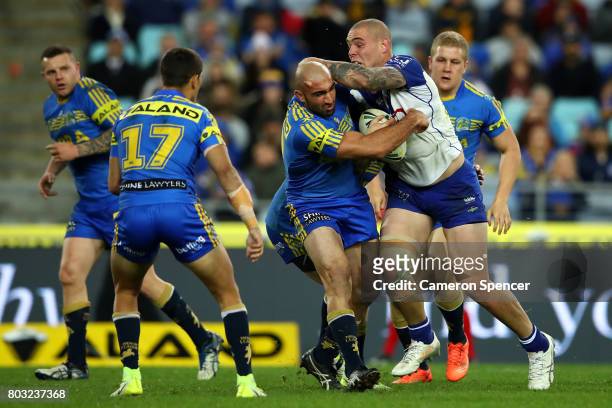 Tim Mannah of the Eels tackles David Klemmer of the Bulldogs during the round 17 NRL match between the Parramatta Eels and the Canterbury Bulldogs at...