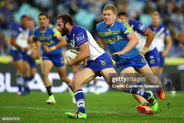 Matthew Frawley of the Bulldogs runs the ball during the round 17 NRL match between the Parramatta Eels and the Canterbury Bulldogs at ANZ Stadium on...