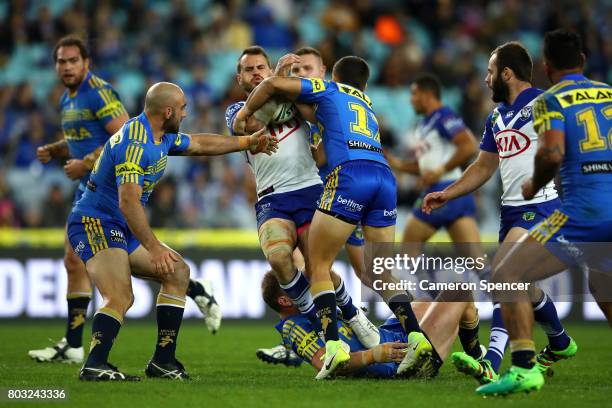 Josh Reynolds of the Bulldogs is tackled during the round 17 NRL match between the Parramatta Eels and the Canterbury Bulldogs at ANZ Stadium on June...