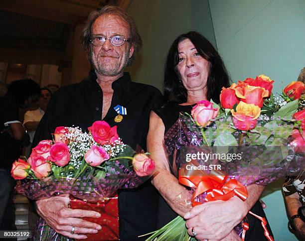 Spanish singer, composer and painter Luis Eduardo Aute and his wife Maria del Carmen Rosado pose for a photo after being decorated with the...