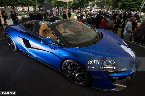 Attendees look at the McLaren 570S Spider during its unveiling at the Goodwood Festival of Speed in Chichester, U.K., on Thursday, June 29, 2017....