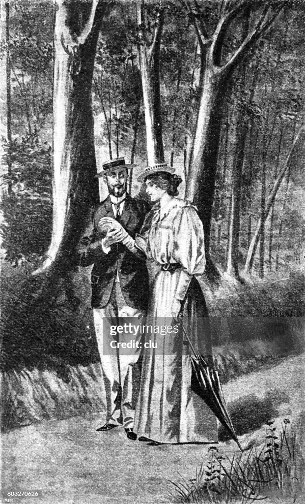 Couple having outdoor walk in forest, holding hands