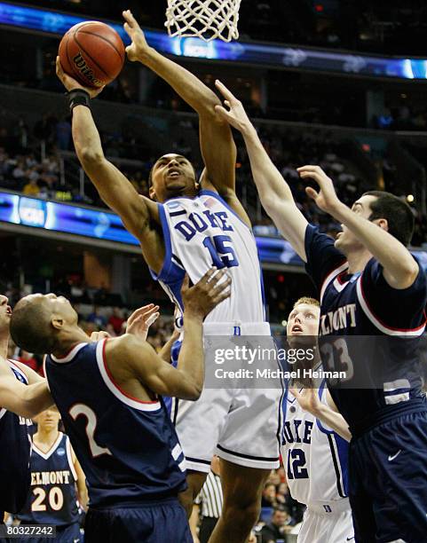 Gerald Henderson of the Duke Blue Devils shoots against Shane Dansby and Will Peeples of the Belmont Bruins during the first round of the West...