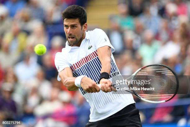 Novak Djokovic of Serbia hits a backhand during the men's singles quarter final match against Donald Young of The United States on day five of the...