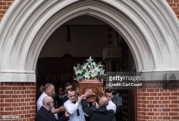 The coffin is carried out of a church after the funeral of one of the victims of the fire in Grenfell Tower, on June 29, 2017 in London, England....