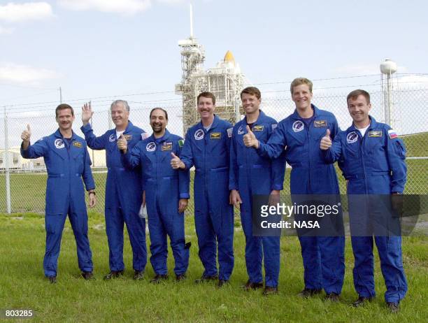 The crew of the STS-100 gives a combined "thumbs up" April 18, 2001 near Launch Pad 39A at the Kennedy Space Center in Florida. Starting at left,...