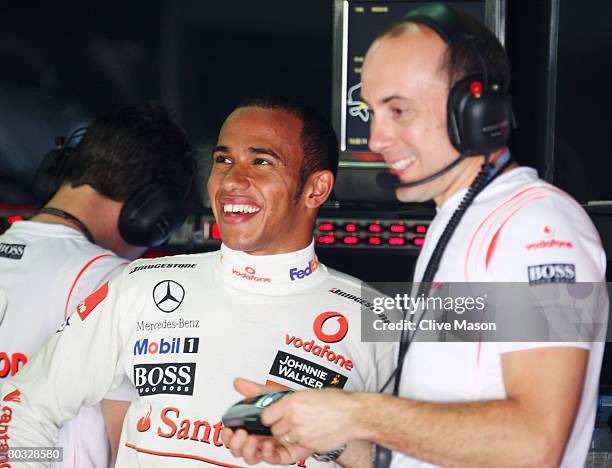 Lewis Hamilton of Great Britain and McLaren Mercedes enjoys a joke in his team garage during practice for the Malaysian Formula One Grand Prix at the...