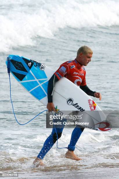 Mick Fanning of Australia runs up the beach during Round Two of the Rip Curl Pro as part of the ASP World Tour held at Bells Beach March 21, 2008 in...